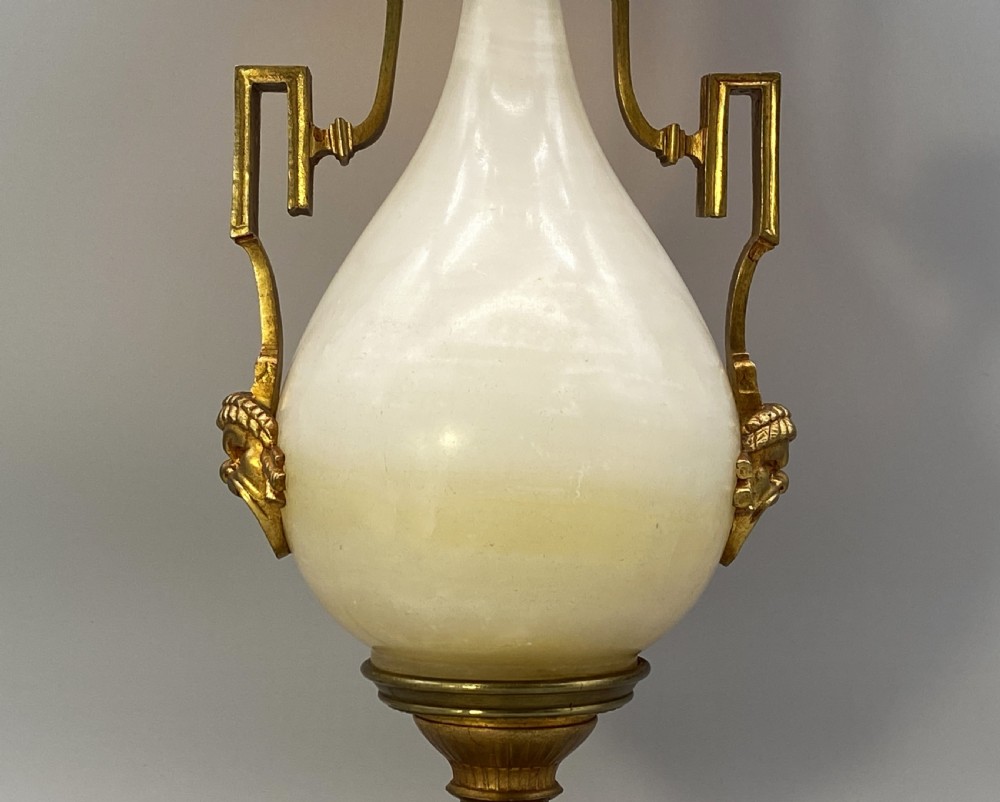 An antique French amphora-shaped white onyx table lamp with gilt metal handles and paw feet, topped with a pleated fabric shade. View XI