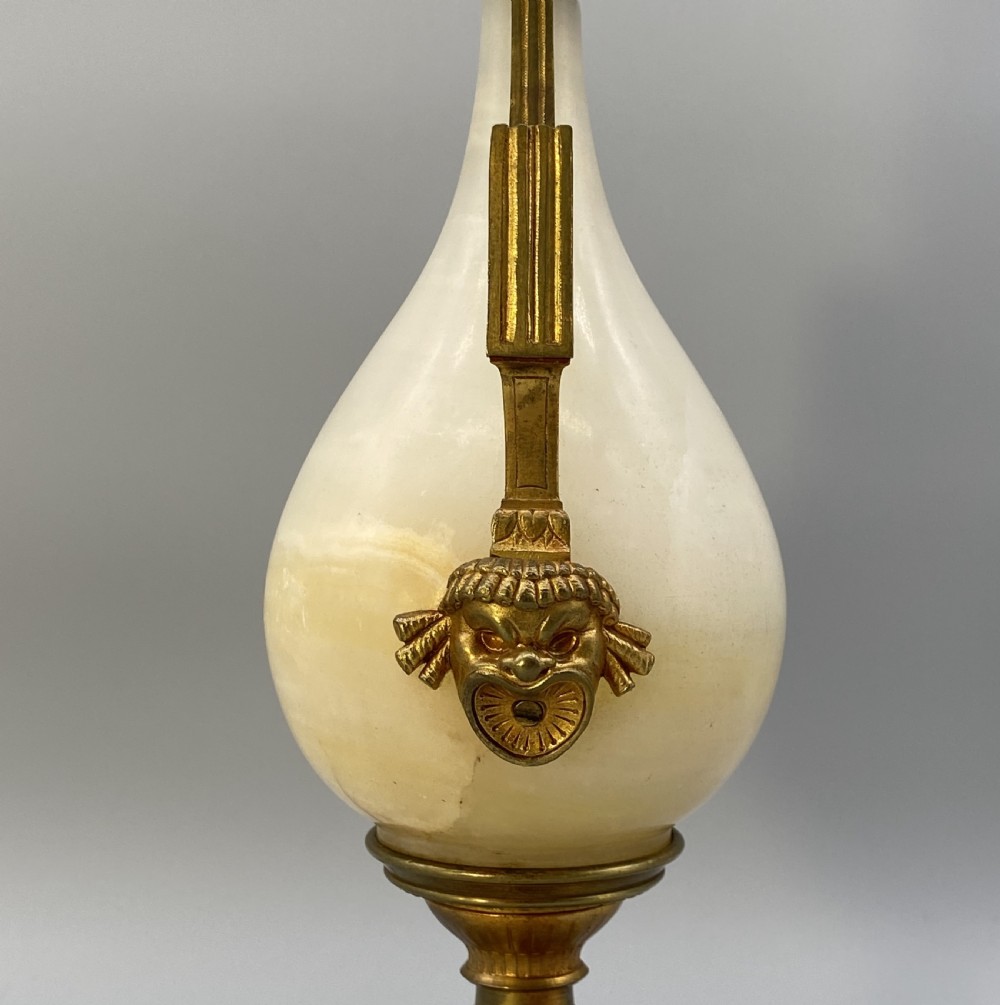 An antique French amphora-shaped white onyx table lamp with gilt metal handles and paw feet, topped with a pleated fabric shade. View XIII