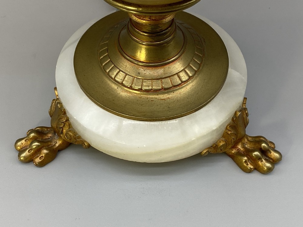 An antique French amphora-shaped white onyx table lamp with gilt metal handles and paw feet, topped with a pleated fabric shade. View XV