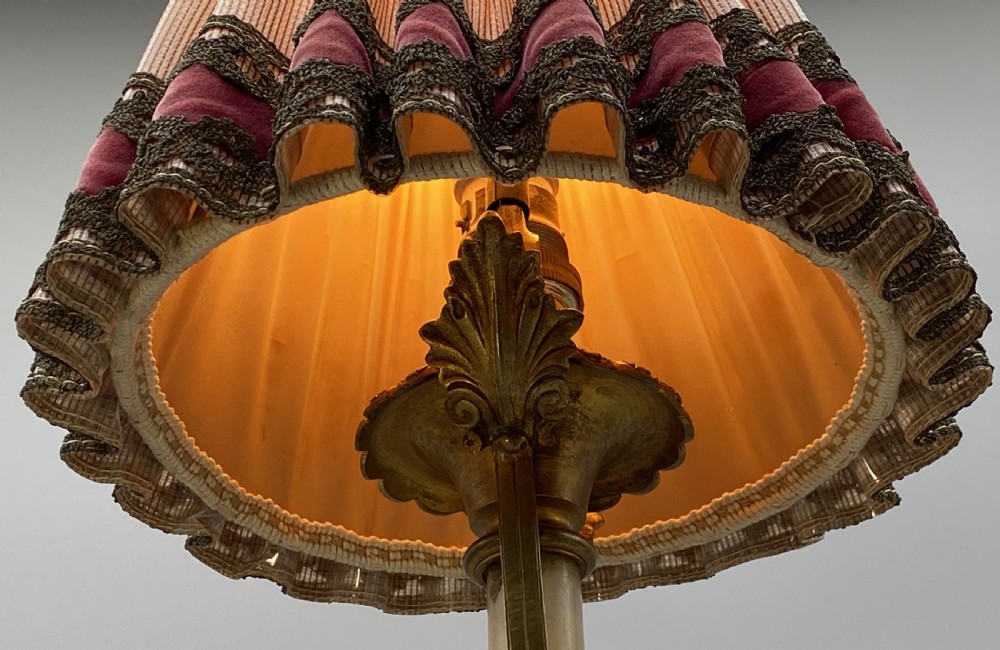 An antique French amphora-shaped white onyx table lamp with gilt metal handles and paw feet, topped with a pleated fabric shade. View XVI