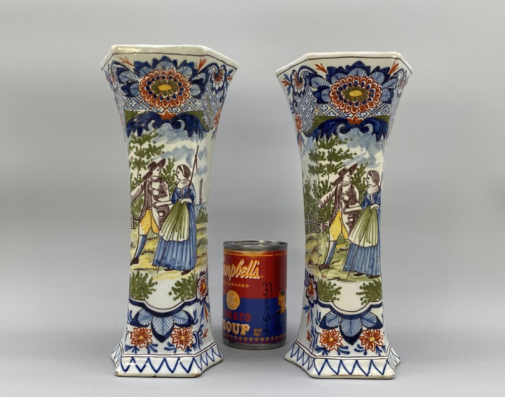 A pair of 18th-century octagonal flared Dutch Delft polychrome tin-glazed earthenware vases featuring hand-painted pastoral scenes of figures in landscape settings framed by floral motifs. View II