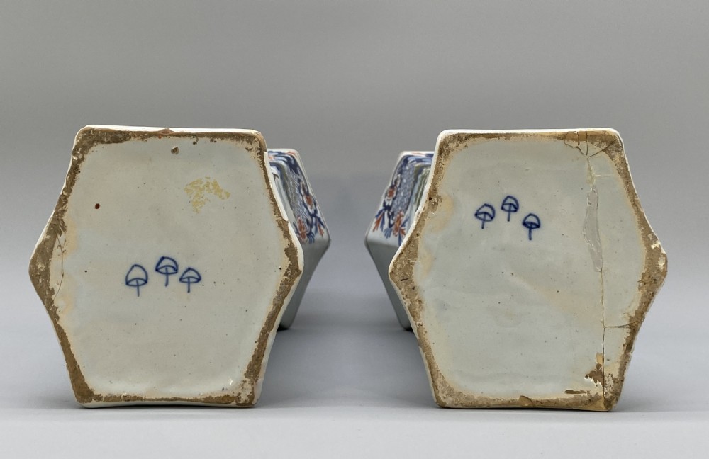 A pair of 18th-century octagonal flared Dutch Delft polychrome tin-glazed earthenware vases featuring hand-painted pastoral scenes of figures in landscape settings framed by floral motifs. View V