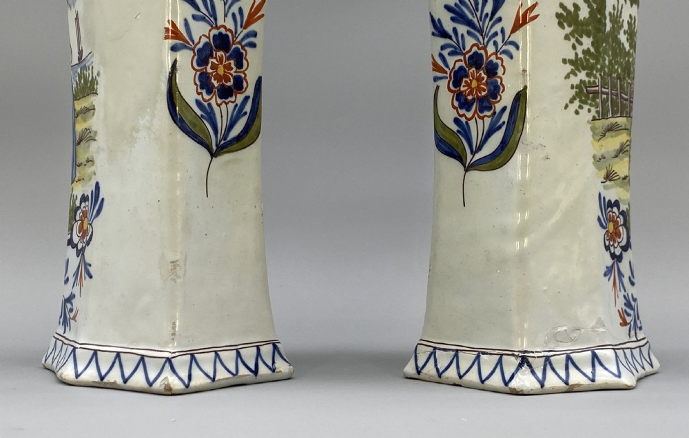 A pair of 18th-century octagonal flared Dutch Delft polychrome tin-glazed earthenware vases featuring hand-painted pastoral scenes of figures in landscape settings framed by floral motifs. View VIII