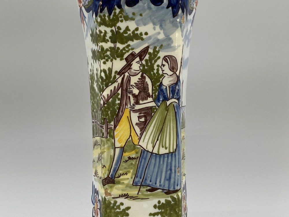 A pair of 18th-century octagonal flared Dutch Delft polychrome tin-glazed earthenware vases featuring hand-painted pastoral scenes of figures in landscape settings framed by floral motifs. View XIII