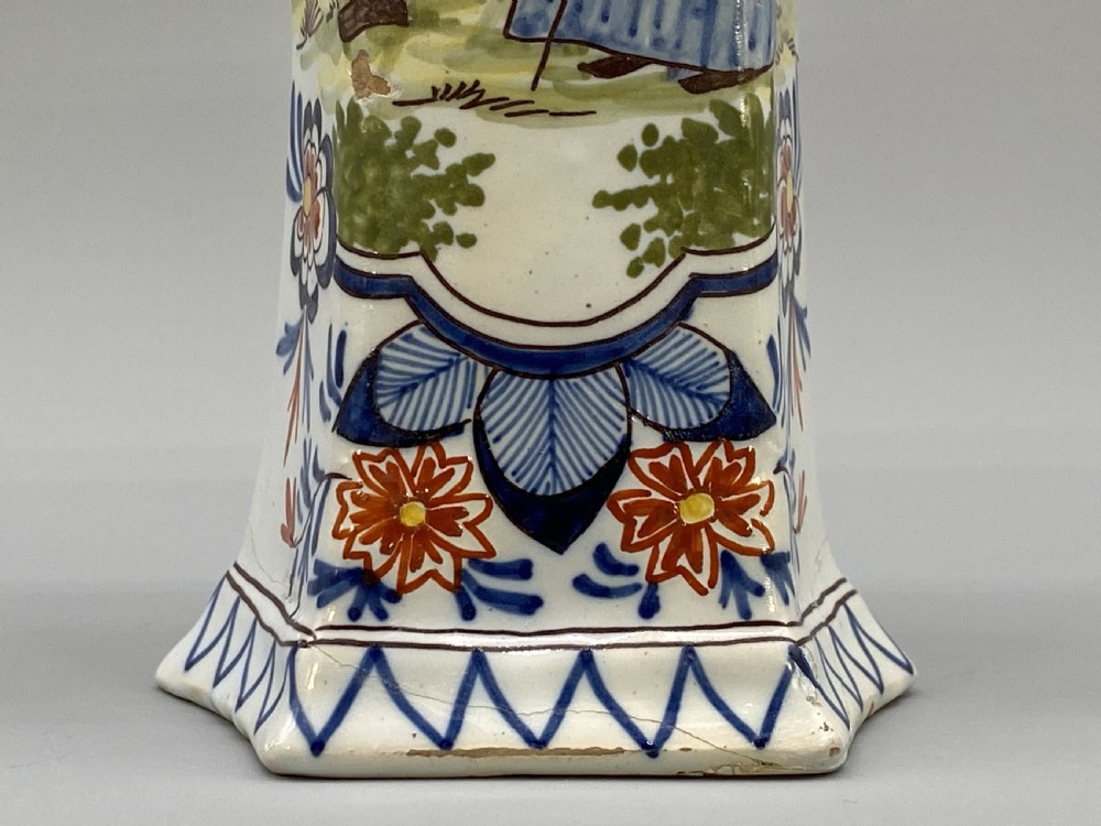 A pair of 18th-century octagonal flared Dutch Delft polychrome tin-glazed earthenware vases featuring hand-painted pastoral scenes of figures in landscape settings framed by floral motifs. View XIV