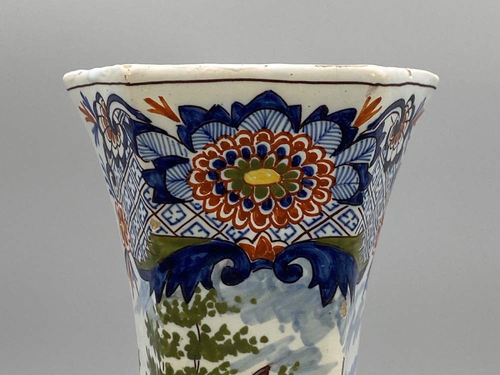 A pair of 18th-century octagonal flared Dutch Delft polychrome tin-glazed earthenware vases featuring hand-painted pastoral scenes of figures in landscape settings framed by floral motifs. View XV