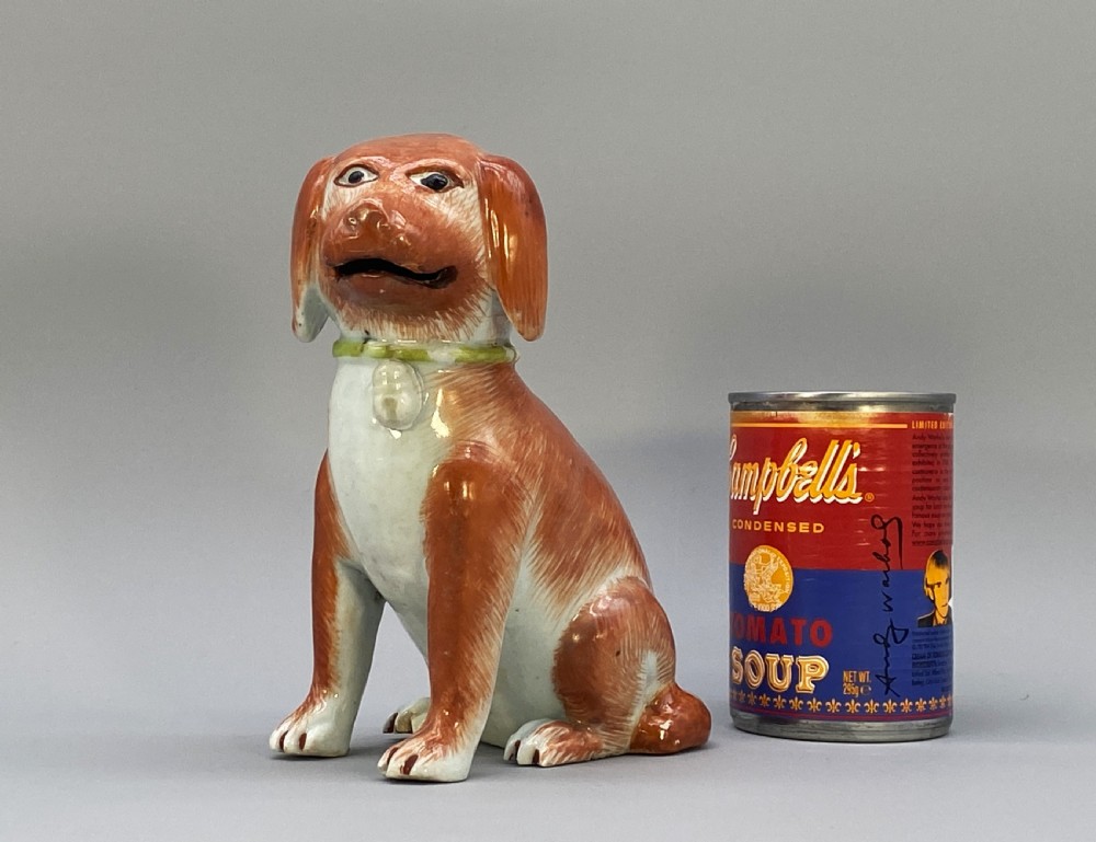 An 18th-century Chinese export porcelain figurine of a seated dog featuring iron-red fur painted details and a light green collar. View II
