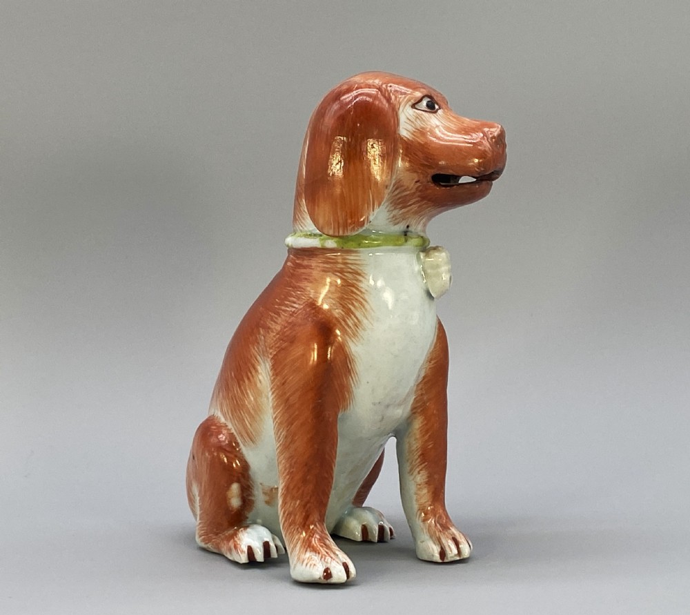 An 18th-century Chinese export porcelain figurine of a seated dog featuring iron-red fur painted details and a light green collar. View V