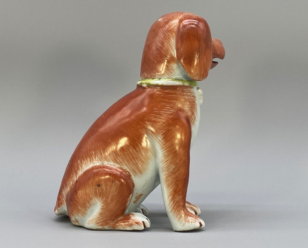 An 18th-century Chinese export porcelain figurine of a seated dog featuring iron-red fur painted details and a light green collar. View VI