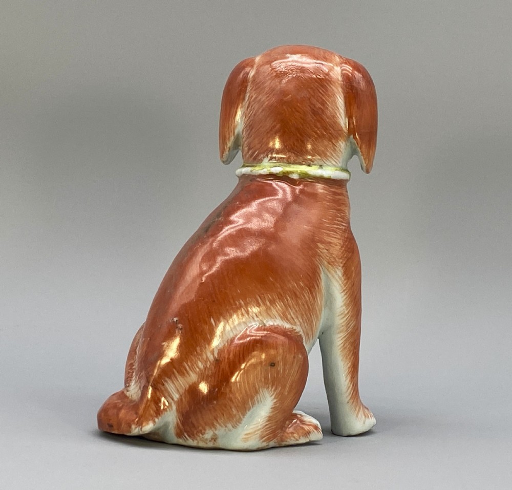 An 18th-century Chinese export porcelain figurine of a seated dog featuring iron-red fur painted details and a light green collar. View VII