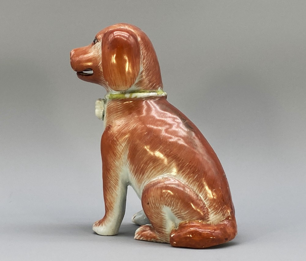 An 18th-century Chinese export porcelain figurine of a seated dog featuring iron-red fur painted details and a light green collar. View VIII