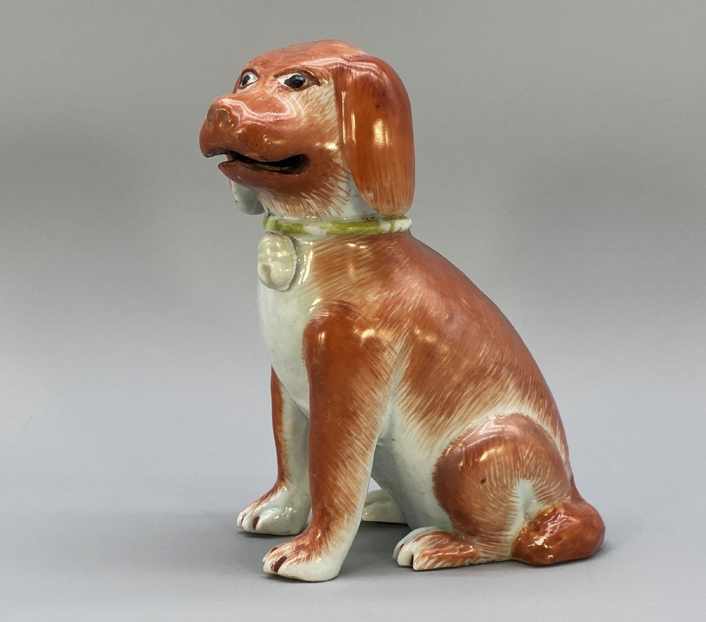 An 18th-century Chinese export porcelain figurine of a seated dog featuring iron-red fur painted details and a light green collar. View IX