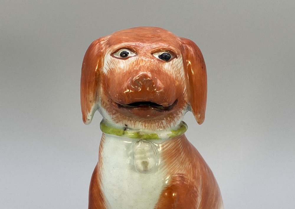An 18th-century Chinese export porcelain figurine of a seated dog featuring iron-red fur painted details and a light green collar. View XI
