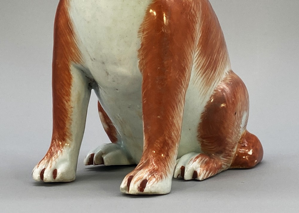 An 18th-century Chinese export porcelain figurine of a seated dog featuring iron-red fur painted details and a light green collar. View XII