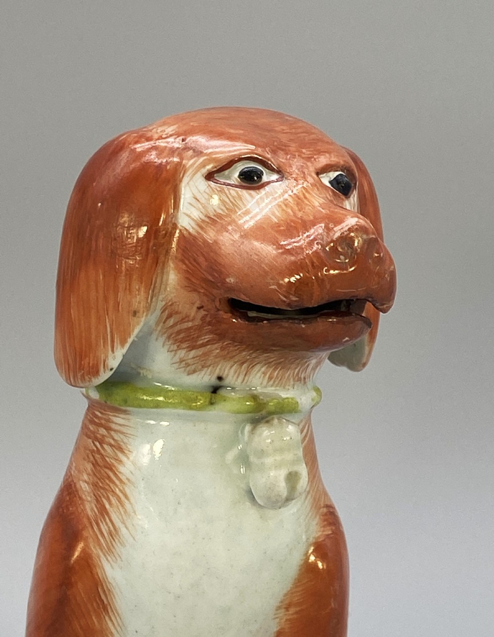 An 18th-century Chinese export porcelain figurine of a seated dog featuring iron-red fur painted details and a light green collar. View XIII