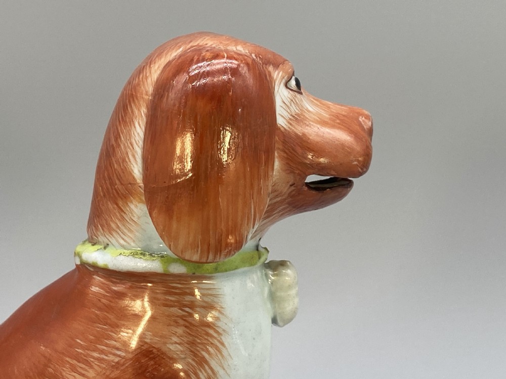An 18th-century Chinese export porcelain figurine of a seated dog featuring iron-red fur painted details and a light green collar. View XVI