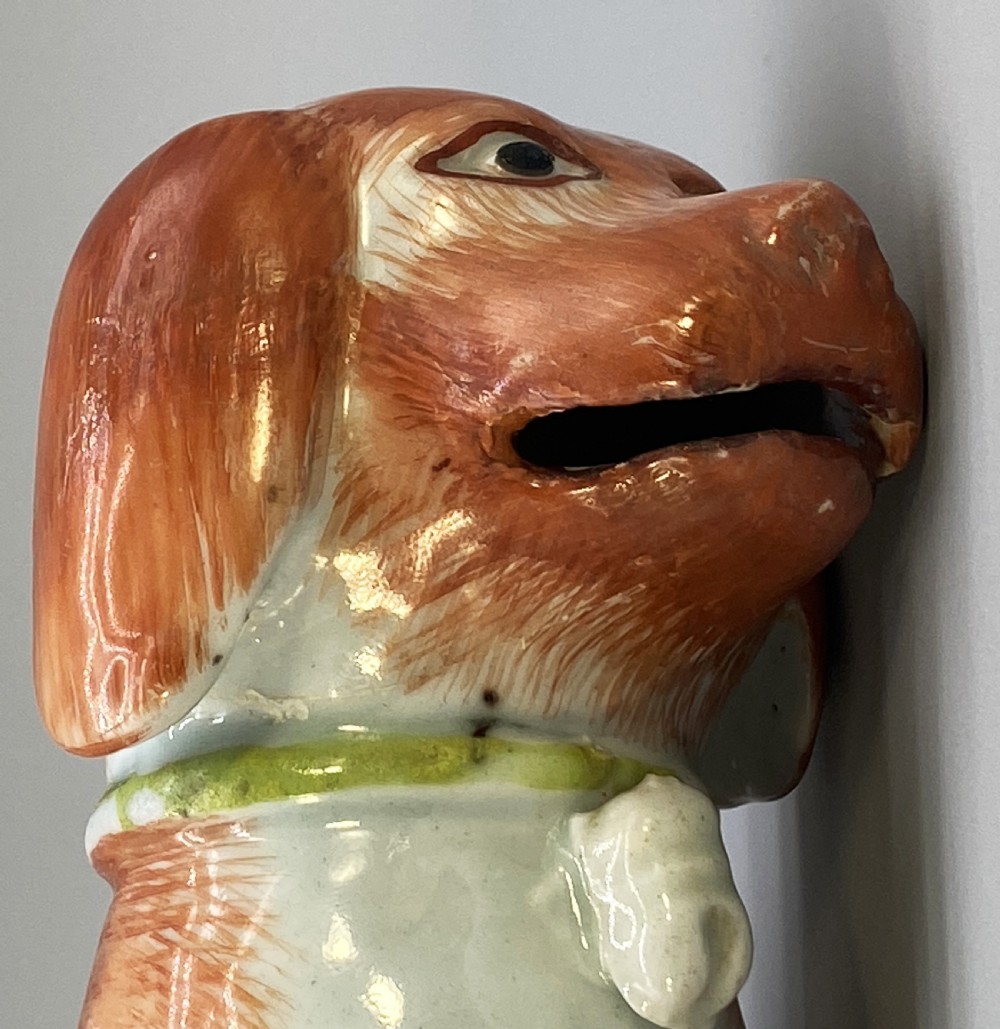 An 18th-century Chinese export porcelain figurine of a seated dog featuring iron-red fur painted details and a light green collar. View XIX