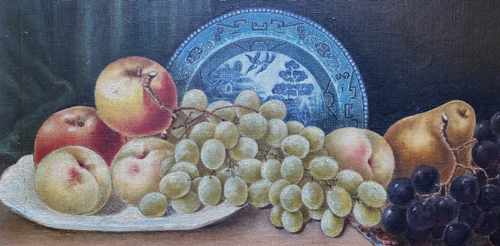 A late 19th-century still life oil painting on canvas depicting fruit and a blue patterned plate, framed in an ornate gilded frame. View III