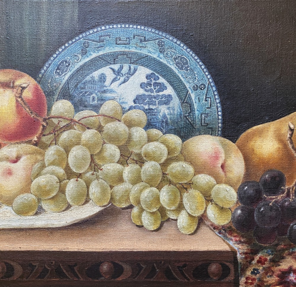 A late 19th-century still life oil painting on canvas depicting fruit and a blue patterned plate, framed in an ornate gilded frame. View IV