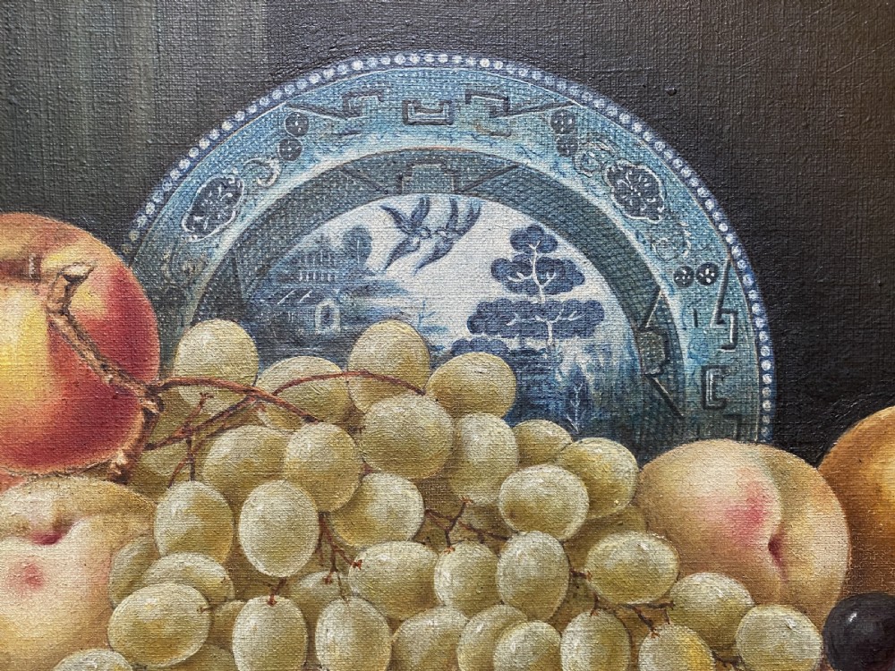 A late 19th-century still life oil painting on canvas depicting fruit and a blue patterned plate, framed in an ornate gilded frame. View VI