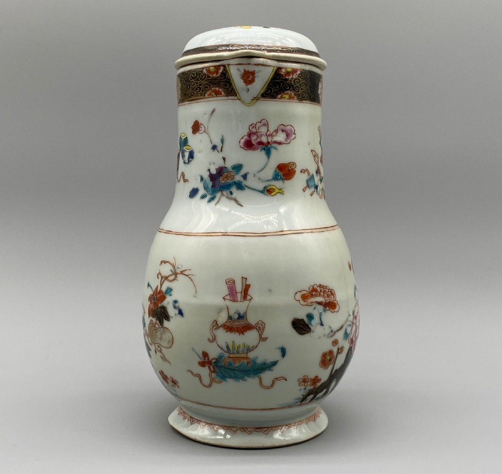 An 18th-century Chinese porcelain jug with hand-painted Famille Rose floral enamels, a metal-mounted lid, and a loop handle. View III