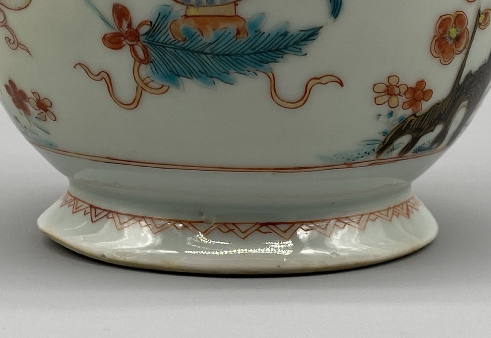 An 18th-century Chinese porcelain jug with hand-painted Famille Rose floral enamels, a metal-mounted lid, and a loop handle. View XI