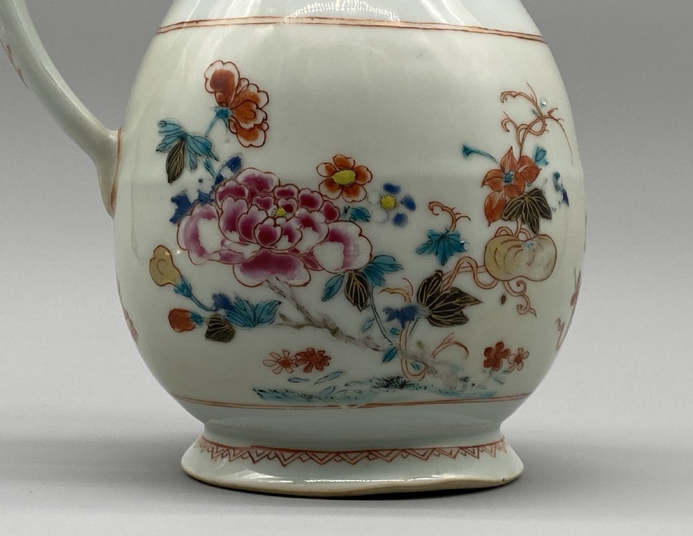 An 18th-century Chinese porcelain jug with hand-painted Famille Rose floral enamels, a metal-mounted lid, and a loop handle. View XIII