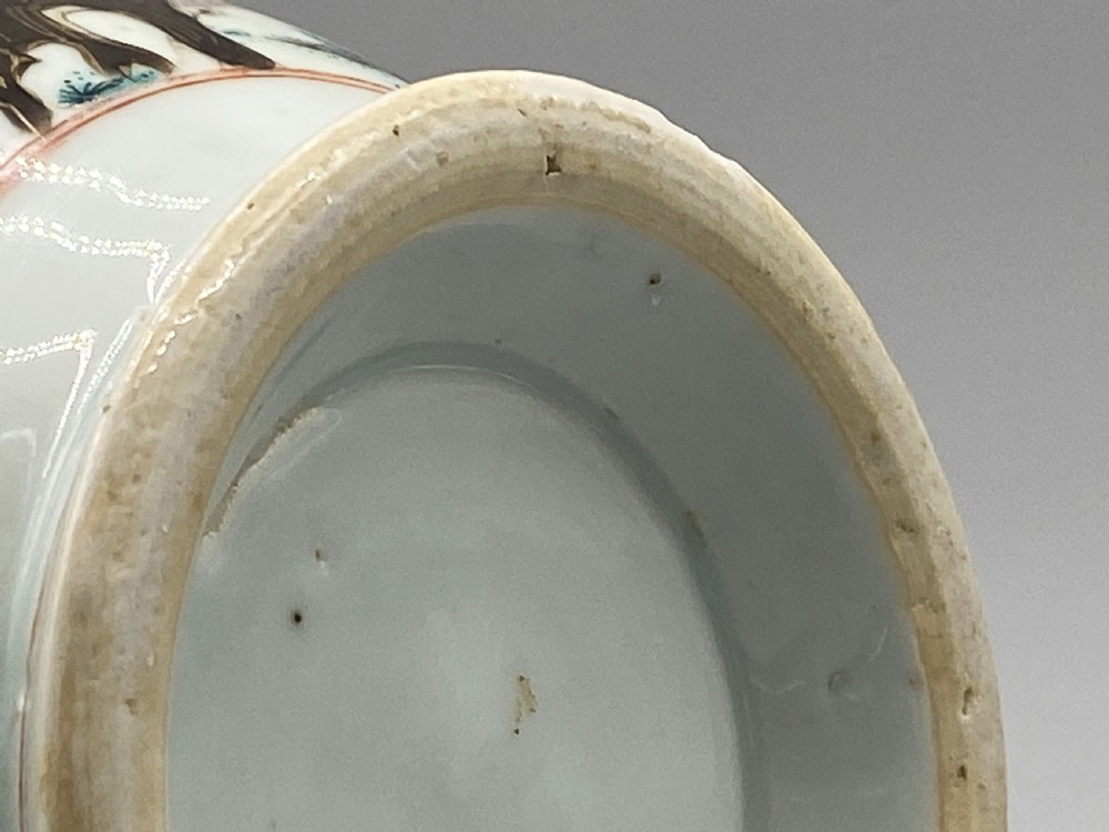 An 18th-century Chinese porcelain jug with hand-painted Famille Rose floral enamels, a metal-mounted lid, and a loop handle. View XVIII