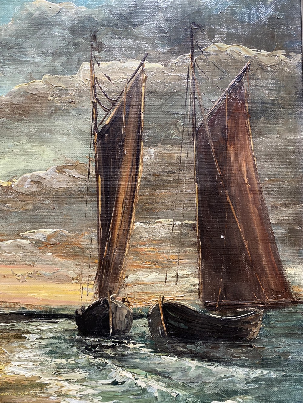 An impressionist oil painting depicting two sailing boats near a shoreline under a dramatic cloudy sky, presented in an ornate gilt frame. View V