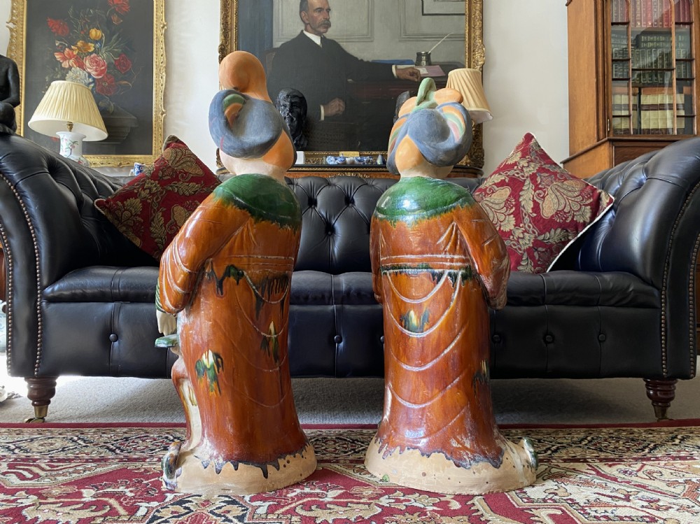 A pair of large Sancai glazed ceramic sculptures depicting Tang Dynasty style female court musicians in orange, green, and cream robes. View VII