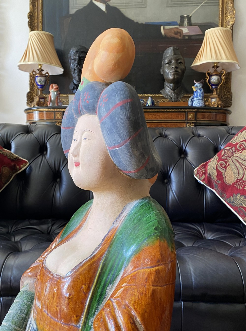 A pair of large Sancai glazed ceramic sculptures depicting Tang Dynasty style female court musicians in orange, green, and cream robes. View X