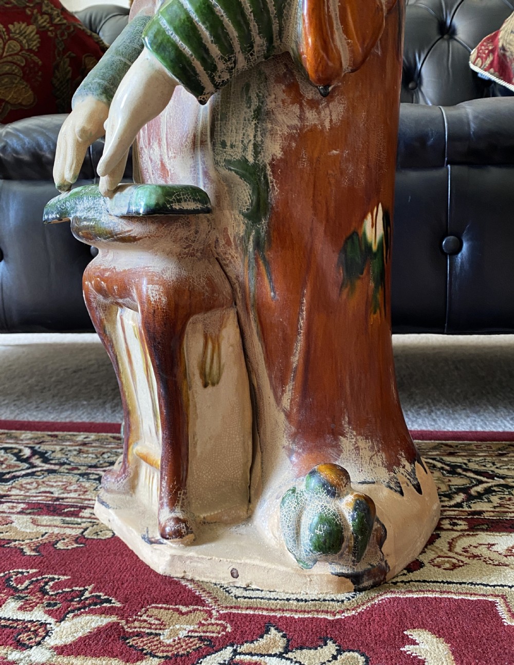 A pair of large Sancai glazed ceramic sculptures depicting Tang Dynasty style female court musicians in orange, green, and cream robes. View XI