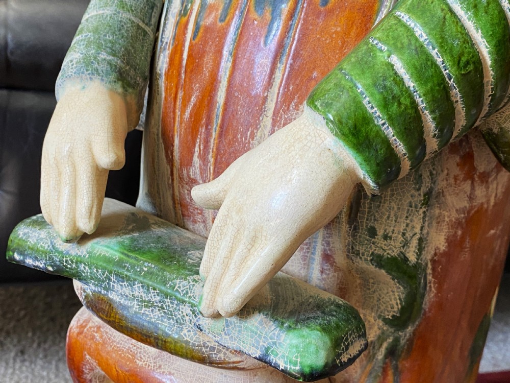 A pair of large Sancai glazed ceramic sculptures depicting Tang Dynasty style female court musicians in orange, green, and cream robes. View XII