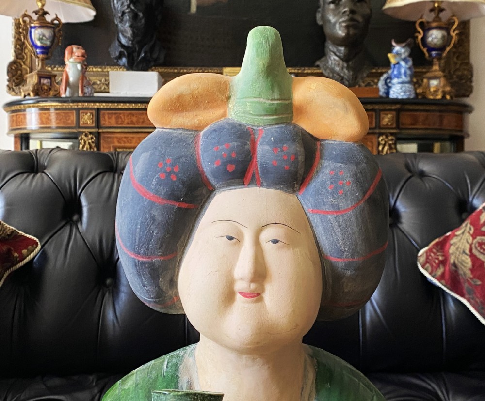 A pair of large Sancai glazed ceramic sculptures depicting Tang Dynasty style female court musicians in orange, green, and cream robes. View XVII