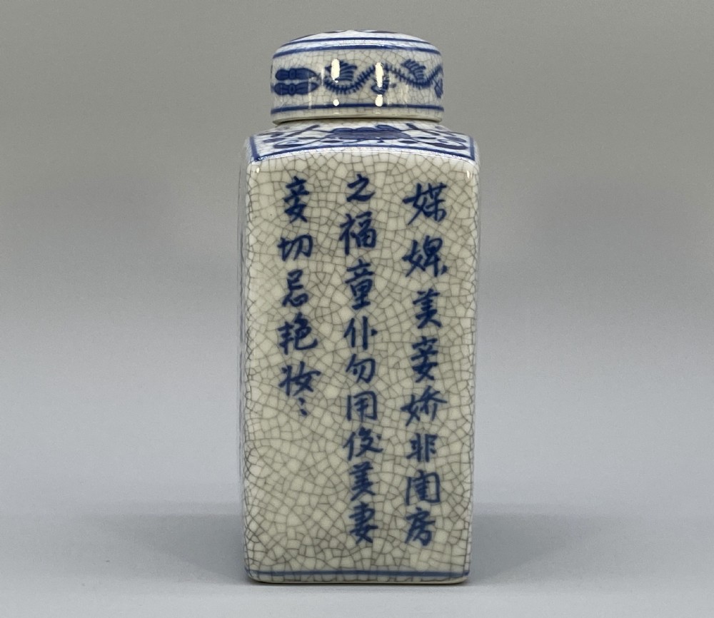 A rectangular blue and white crackle-glazed porcelain canister with a fitted lid, featuring vertical columns of hand-painted Chinese calligraphy. View V