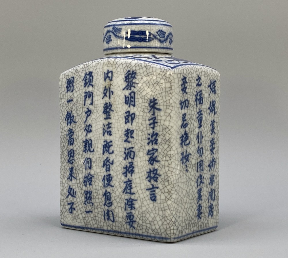 A rectangular blue and white crackle-glazed porcelain canister with a fitted lid, featuring vertical columns of hand-painted Chinese calligraphy. View VI