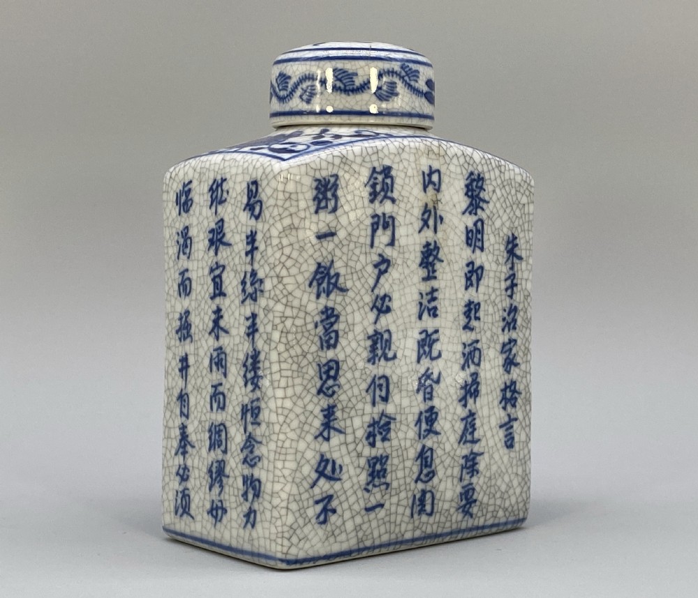 A rectangular blue and white crackle-glazed porcelain canister with a fitted lid, featuring vertical columns of hand-painted Chinese calligraphy. View VIII
