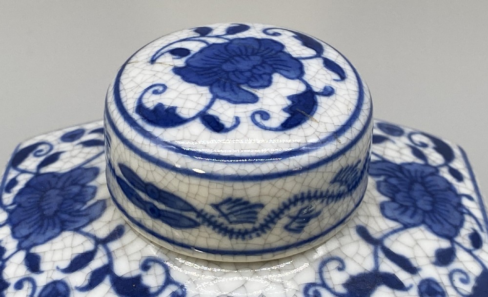 A rectangular blue and white crackle-glazed porcelain canister with a fitted lid, featuring vertical columns of hand-painted Chinese calligraphy. View IX