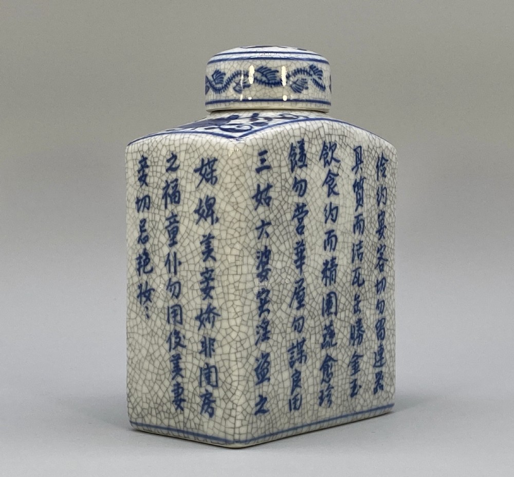 A rectangular blue and white crackle-glazed porcelain canister with a fitted lid, featuring vertical columns of hand-painted Chinese calligraphy. View XV