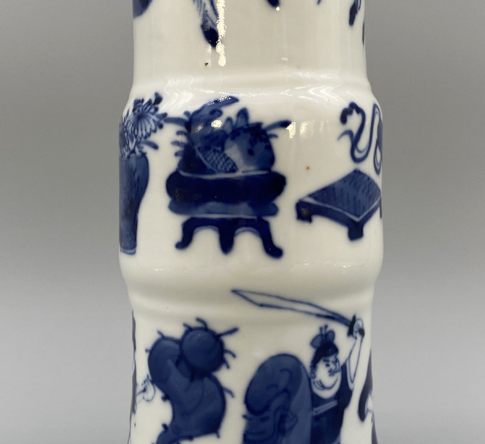 A tall, slender Chinese porcelain beaker vase painted in underglaze cobalt blue featuring equestrian figures and traditional motifs against a smooth white glaze. View VII
