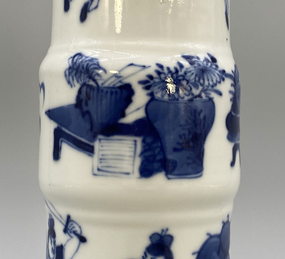 A tall, slender Chinese porcelain beaker vase painted in underglaze cobalt blue featuring equestrian figures and traditional motifs against a smooth white glaze. View XV