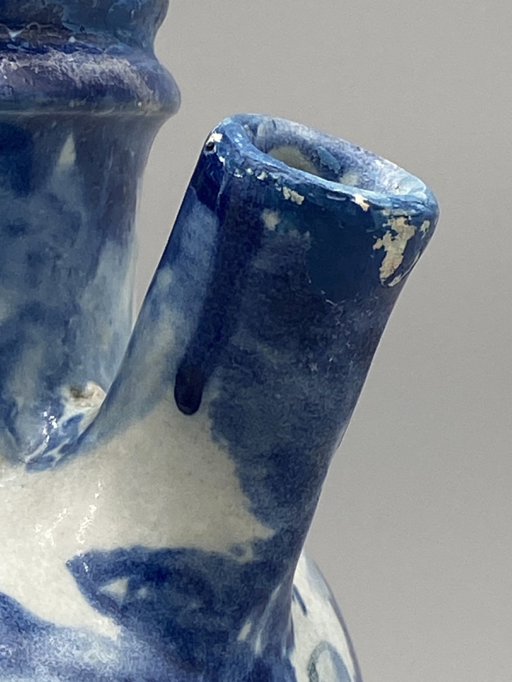 An 18th-century Italian Savona majolica wet drug jar featuring hand-painted cobalt blue landscapes, a single side handle, a raised spout, and a pedestal base. View XIV