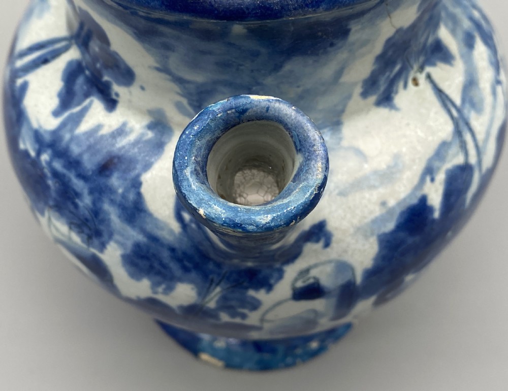 An 18th-century Italian Savona majolica wet drug jar featuring hand-painted cobalt blue landscapes, a single side handle, a raised spout, and a pedestal base. View XVI