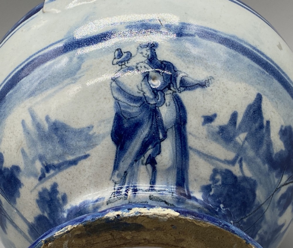 An 18th-century Italian Savona majolica wet drug jar featuring hand-painted cobalt blue landscapes, a single side handle, a raised spout, and a pedestal base. View XIX