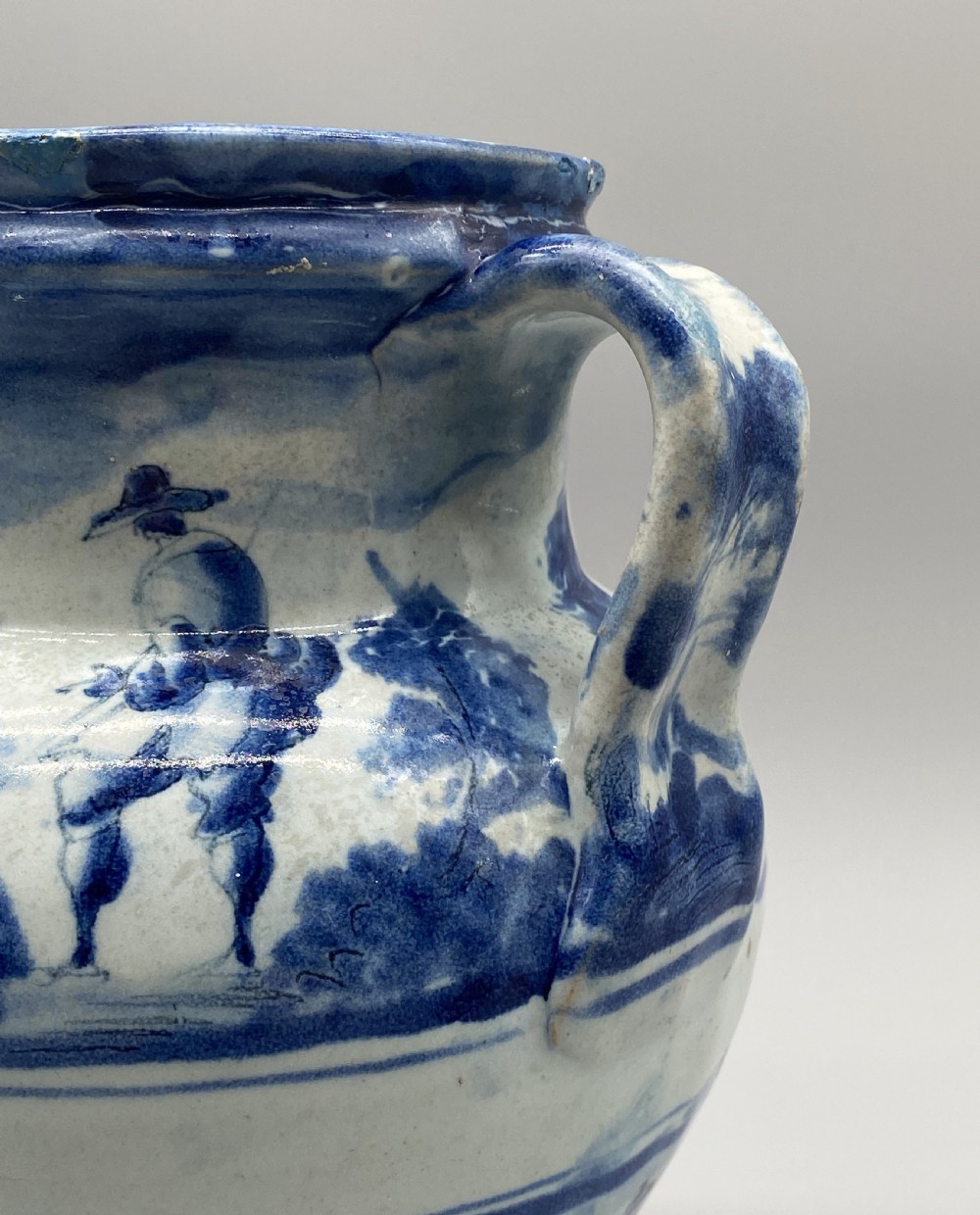 An 18th-century Italian Savona majolica wet drug jar featuring hand-painted cobalt blue landscapes, a single side handle, a raised spout, and a pedestal base. View XXI