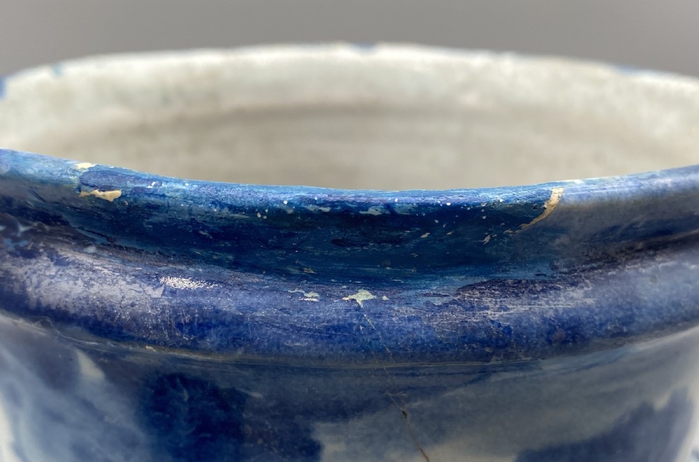 An 18th-century Italian Savona majolica wet drug jar featuring hand-painted cobalt blue landscapes, a single side handle, a raised spout, and a pedestal base. View XXII
