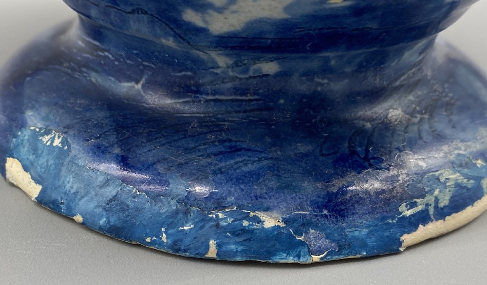 An 18th-century Italian Savona majolica wet drug jar featuring hand-painted cobalt blue landscapes, a single side handle, a raised spout, and a pedestal base. View XXIII
