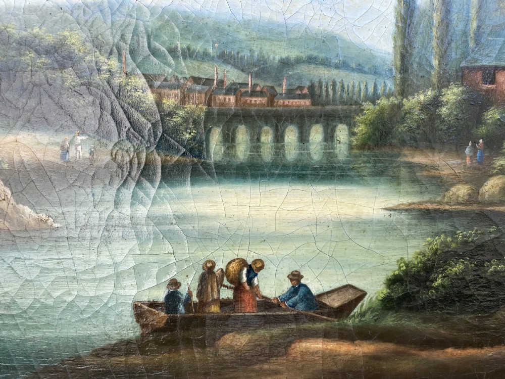 A 19th-century Italian School oil painting depicting a lakeside landscape with figures in a boat, towering cliffs, and a clouded blue sky inside a gilt frame. View XI
