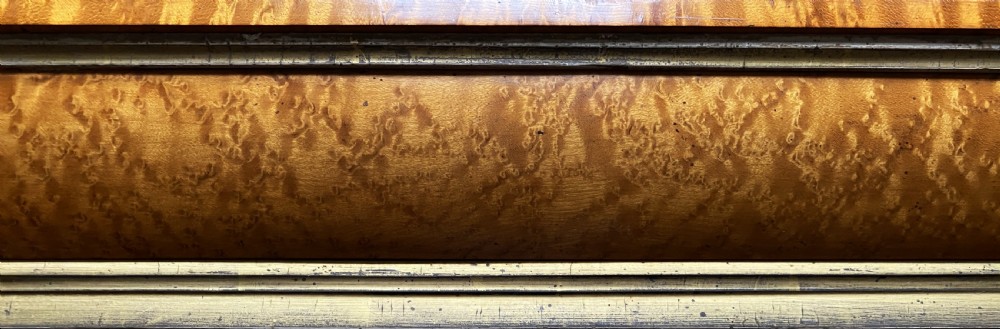 An antique Biedermeier picture frame crafted from birds eye maple veneer with an inner gilt slip enclosing a needlework tapestry. View XI