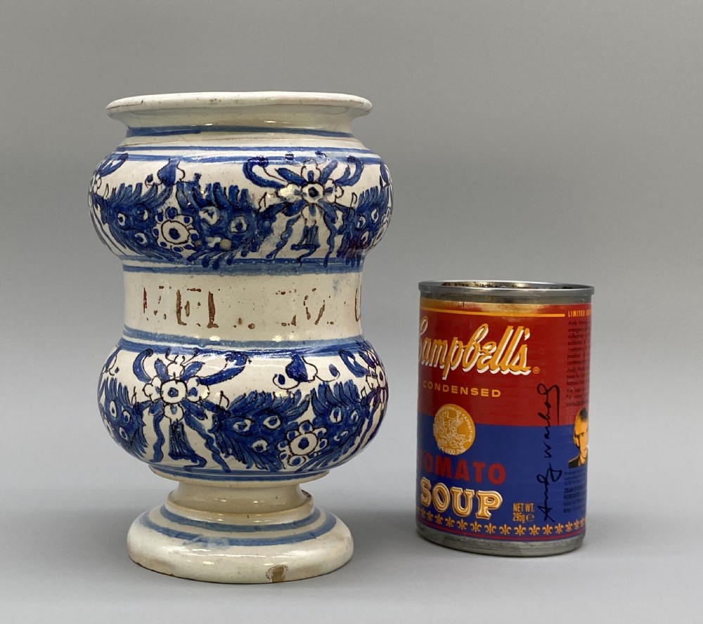 An 18th-century Italian majolica albarello pharmacy jar featuring a waisted silhouette with hand-painted blue floral patterns and central apothecary inscription. View II